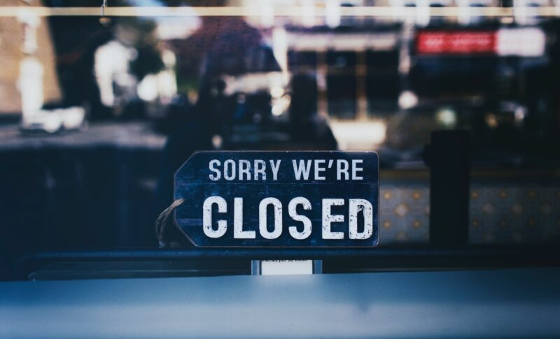 close up photo of sorry we re closed sign on glass window